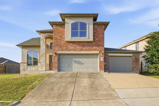 a front view of a house with yard