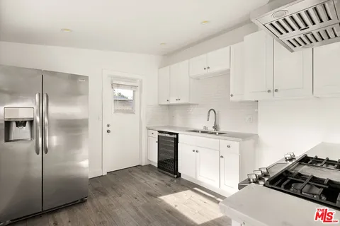a kitchen with stainless steel appliances granite countertop a stove and a refrigerator