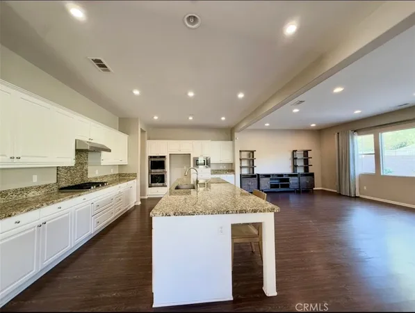 an open kitchen with a table and chairs