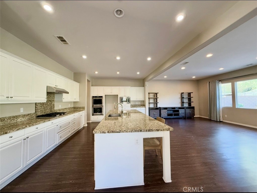 667 Desert Willow Road Azusa, CA 91702 - Photo 26 of 75 a large kitchen with stainless steel appliances kitchen island granite countertop a large counter top stainless steel appliances and cabinets