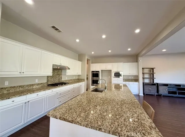 an open kitchen with a table and chairs in it