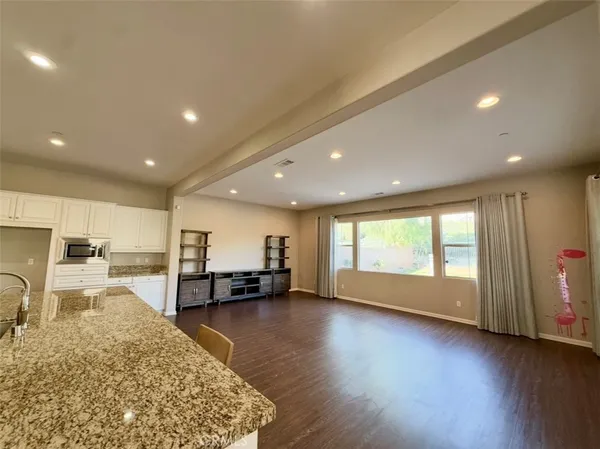 a dining room with furniture and wooden floor