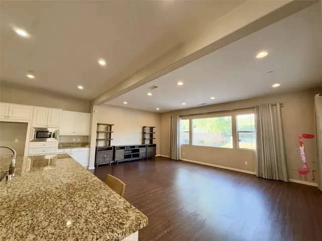 a dining room with furniture and wooden floor