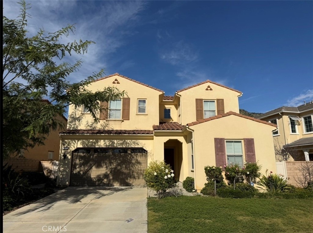 667 Desert Willow Road Azusa, CA 91702 - Photo 3 of 75 a front view of a house with a garden