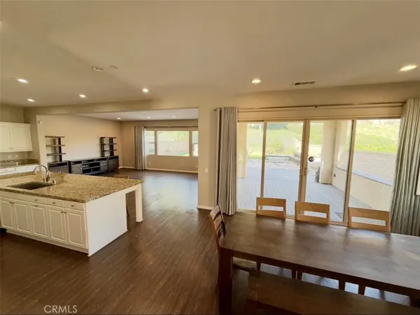 a view of large kitchen with wooden floor and a kitchen