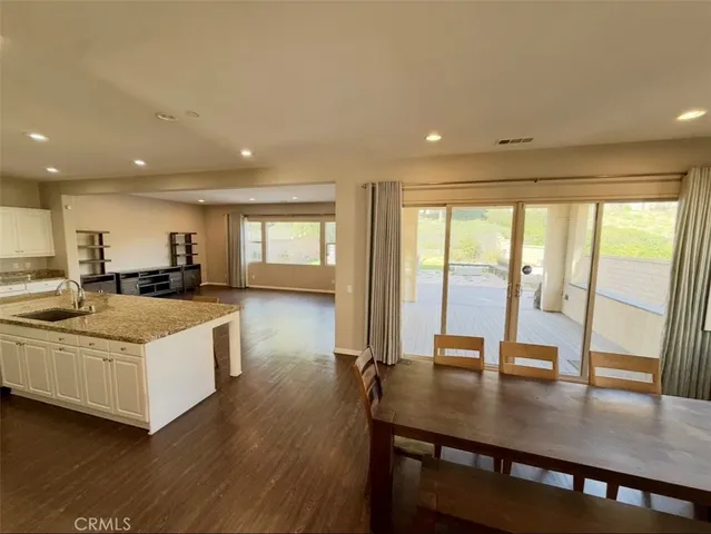 a view of large kitchen with wooden floor and a kitchen