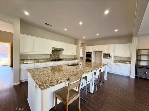 a utility room with cabinets washer and dryer