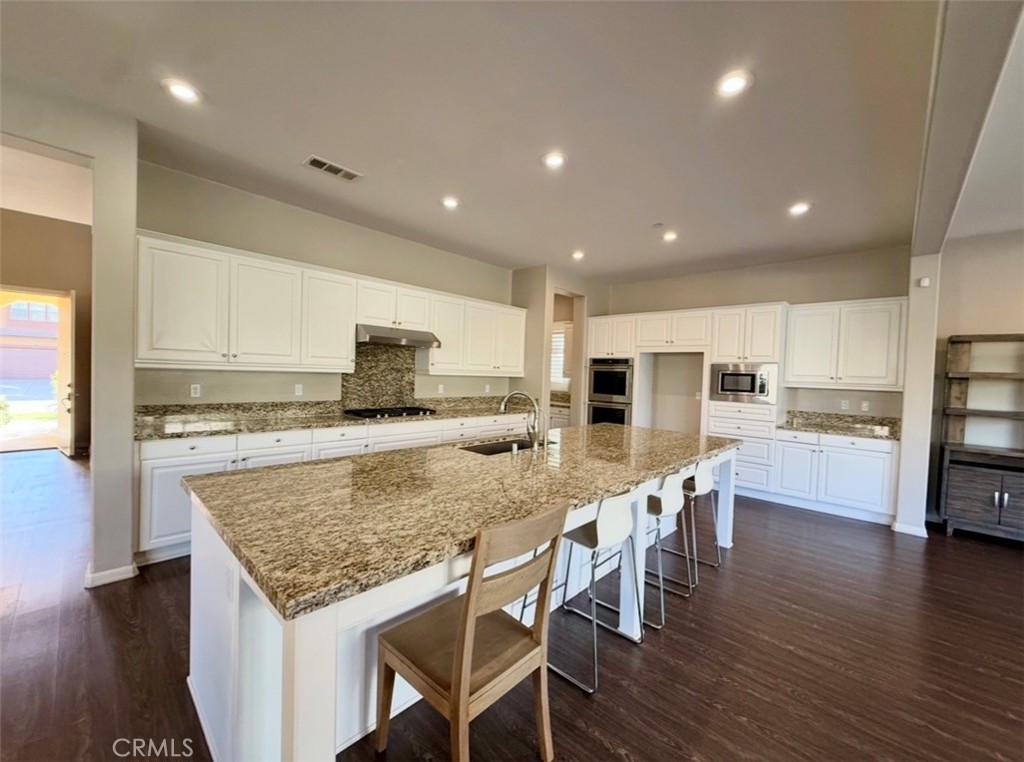 667 Desert Willow Road Azusa, CA 91702 - Photo 43 of 75 a kitchen with a table and chairs in it