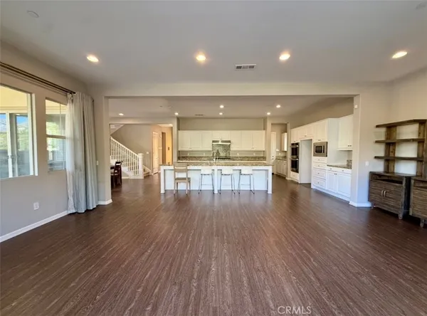 a spacious bathroom with a mirror a sink and a shower