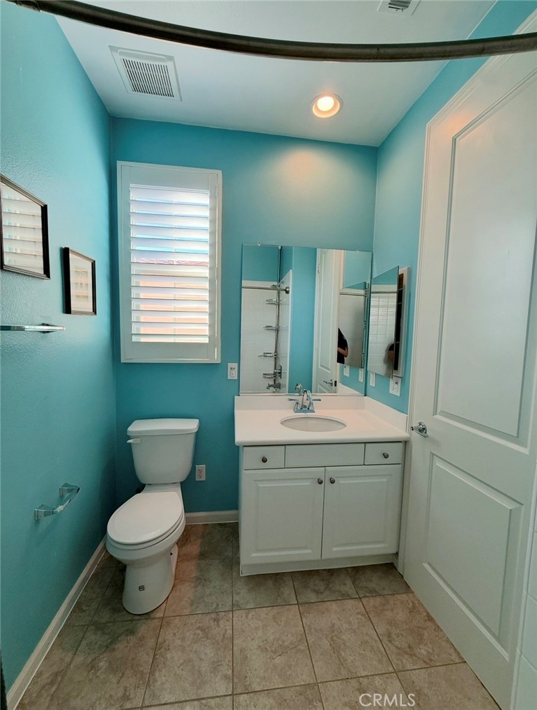 667 Desert Willow Road Azusa, CA 91702 - Photo 60 of 75 a bathroom with a granite countertop toilet a sink and a mirror