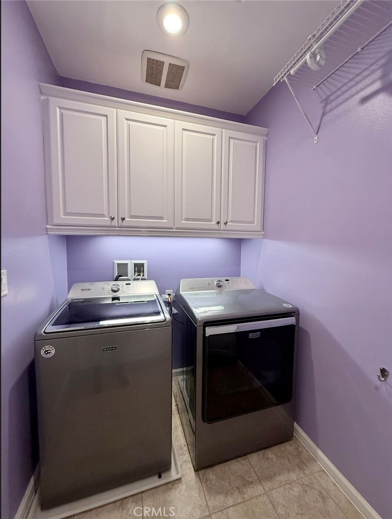 667 Desert Willow Road Azusa, CA 91702 - Photo 62 of 75 a view of washer and dryer with kitchen in the background