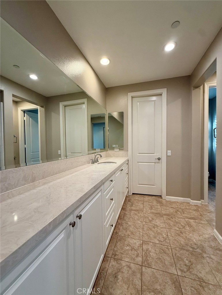 667 Desert Willow Road Azusa, CA 91702 - Photo 67 of 75 a spacious bathroom with a mirror a sink and a shower