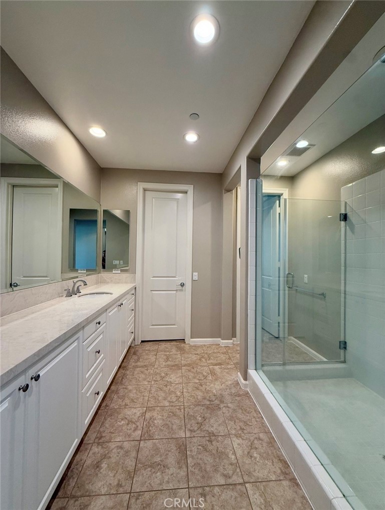 667 Desert Willow Road Azusa, CA 91702 - Photo 68 of 75 a bathroom with a mirror a sink and shower