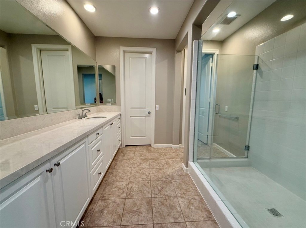 667 Desert Willow Road Azusa, CA 91702 - Photo 69 of 75 a spacious bathroom with a mirror a shower and a sink