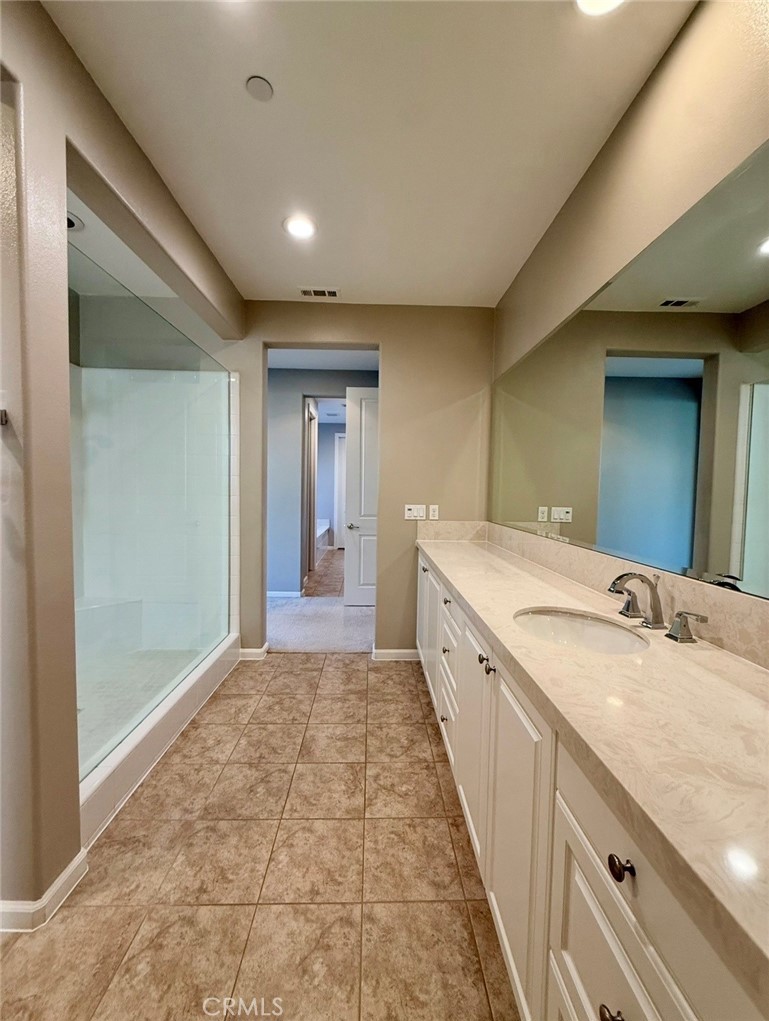 667 Desert Willow Road Azusa, CA 91702 - Photo 71 of 75 a spacious bathroom with a granite countertop sink a mirror and a shower