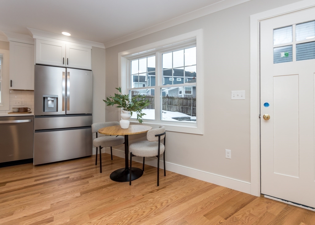 89 Hardy Pond Road Waltham, MA 02451 - Photo 13 of 39 a kitchen with stainless steel appliances wooden floor and dining table