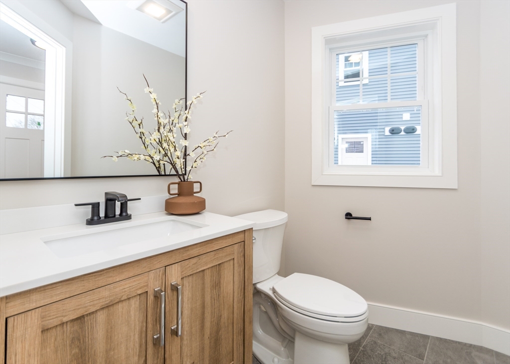 89 Hardy Pond Road Waltham, MA 02451 - Photo 16 of 39 a bathroom with a granite countertop toilet sink and mirror