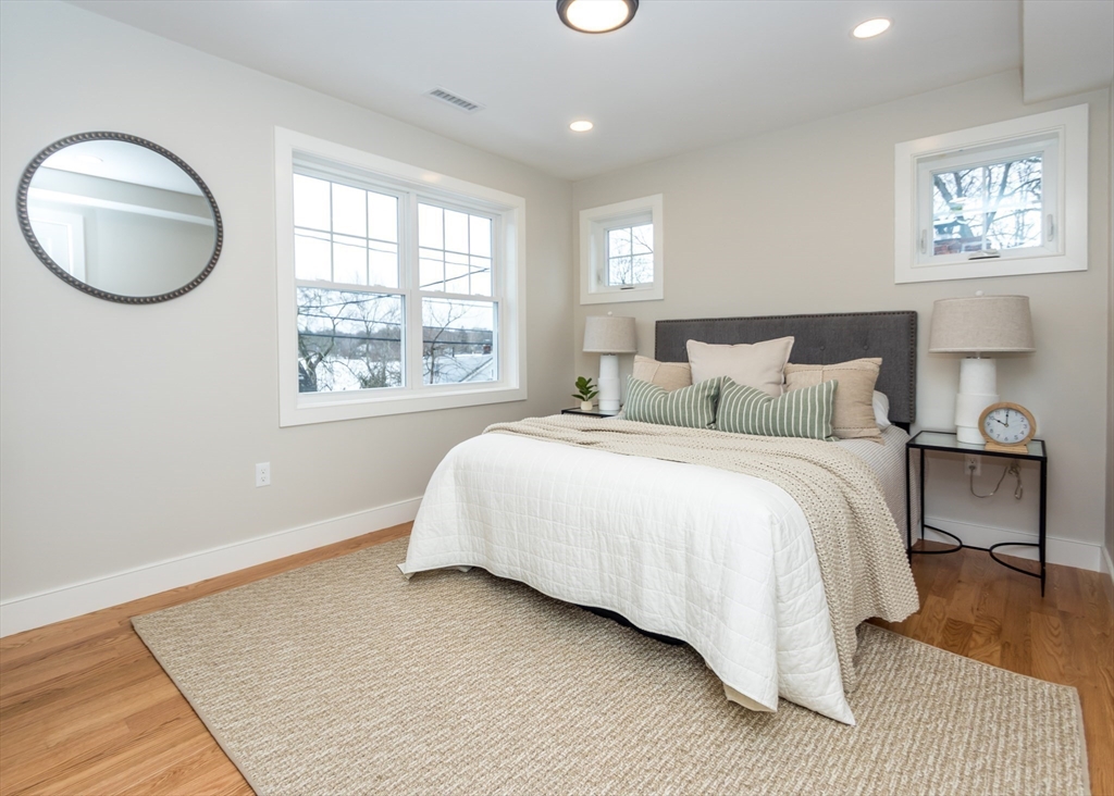 89 Hardy Pond Road Waltham, MA 02451 - Photo 18 of 39 a bedroom with a bed and a painting on the wall
