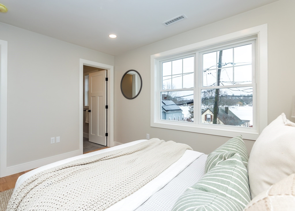 89 Hardy Pond Road Waltham, MA 02451 - Photo 19 of 39 a bedroom with a large bed and a large window