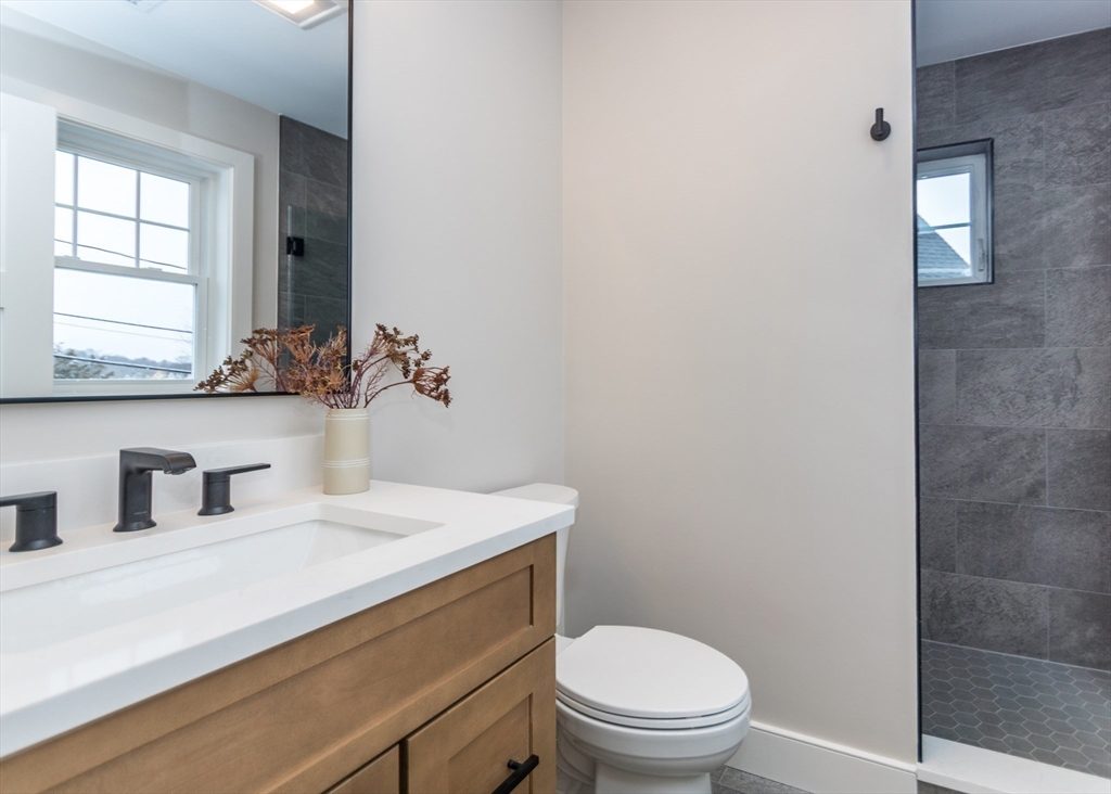 89 Hardy Pond Road Waltham, MA 02451 - Photo 20 of 39 a bathroom with a sink a toilet and window