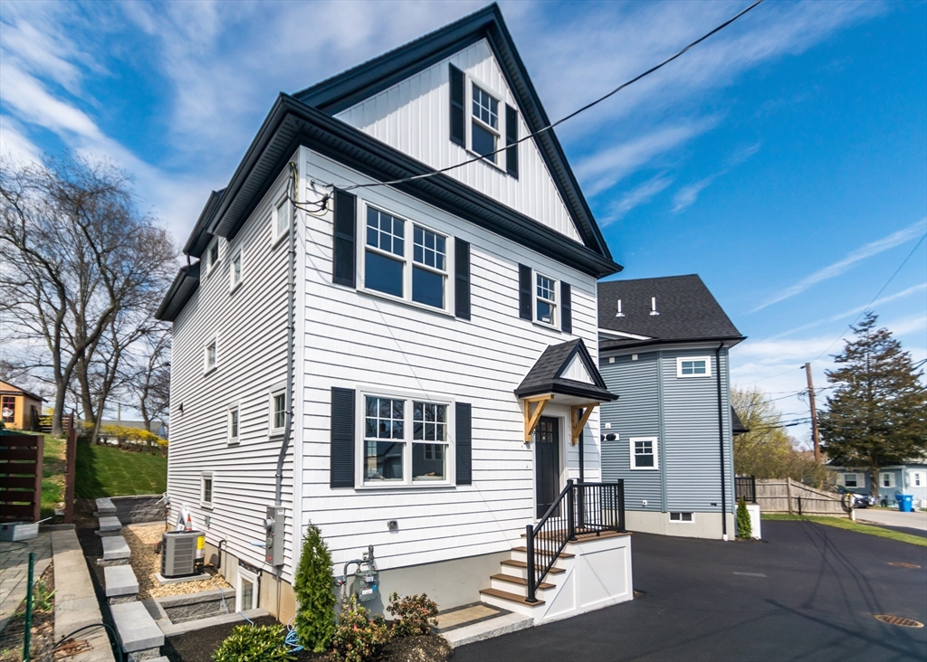 89 Hardy Pond Road Waltham, MA 02451 - Photo 2 of 39 a front view of a house with a yard