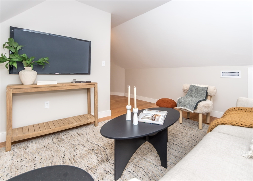 89 Hardy Pond Road Waltham, MA 02451 - Photo 27 of 39 a living room with furniture and a table