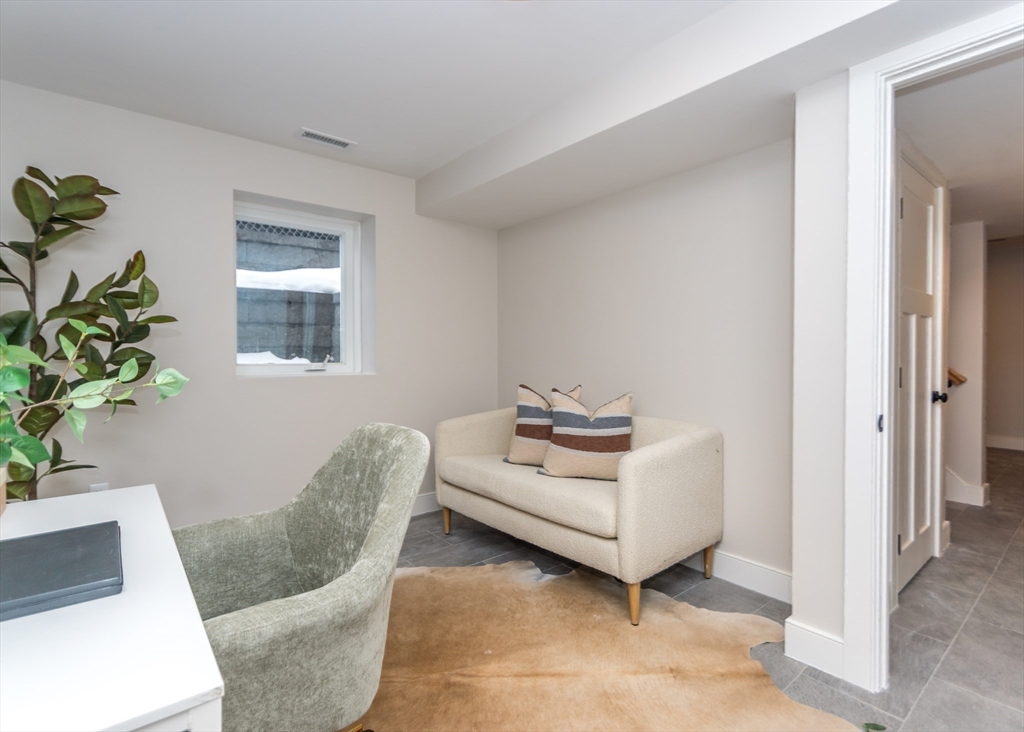 89 Hardy Pond Road Waltham, MA 02451 - Photo 32 of 39 a living room with furniture and a potted plant