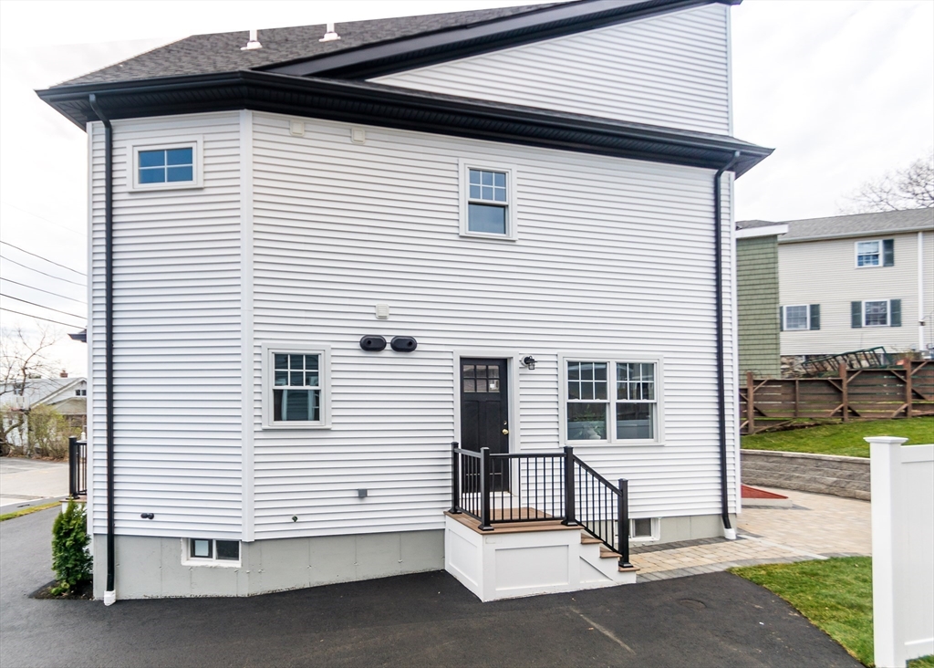 89 Hardy Pond Road Waltham, MA 02451 - Photo 35 of 39 a view of a house with a yard and lawn chairs