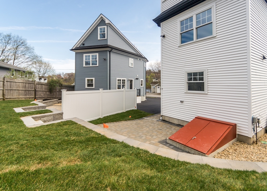 89 Hardy Pond Road Waltham, MA 02451 - Photo 37 of 39 a front view of a house with a yard