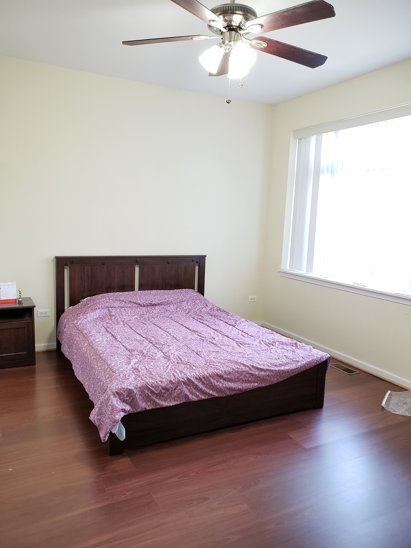3554 South Dearborn Street Chicago, IL 60609 - Photo 12 of 22 a bedroom with a bed and window