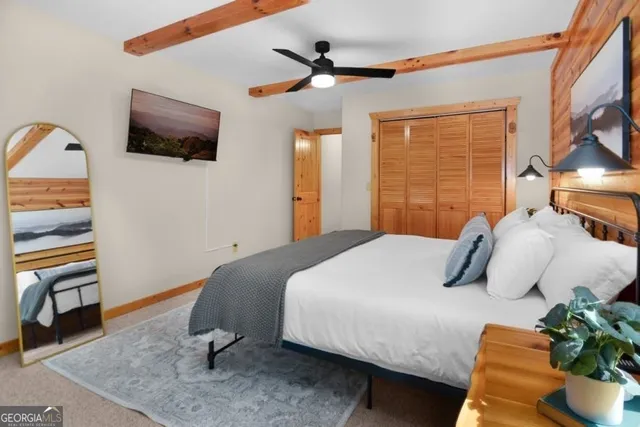 a bedroom with a bed and a television