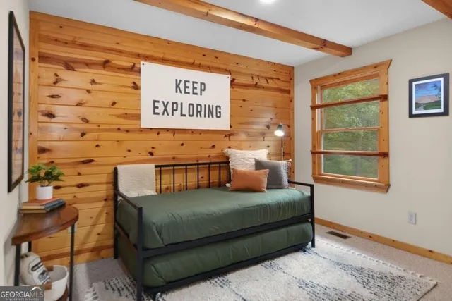 a bedroom with a bed and a window