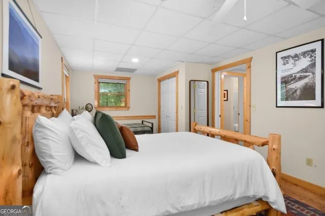 a bedroom with a large bed and flat tv screen