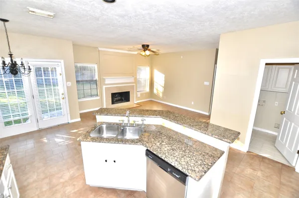 a living room with granite countertop furniture and a fireplace