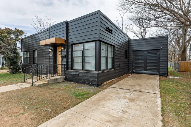 a view of house with backyard and sitting area
