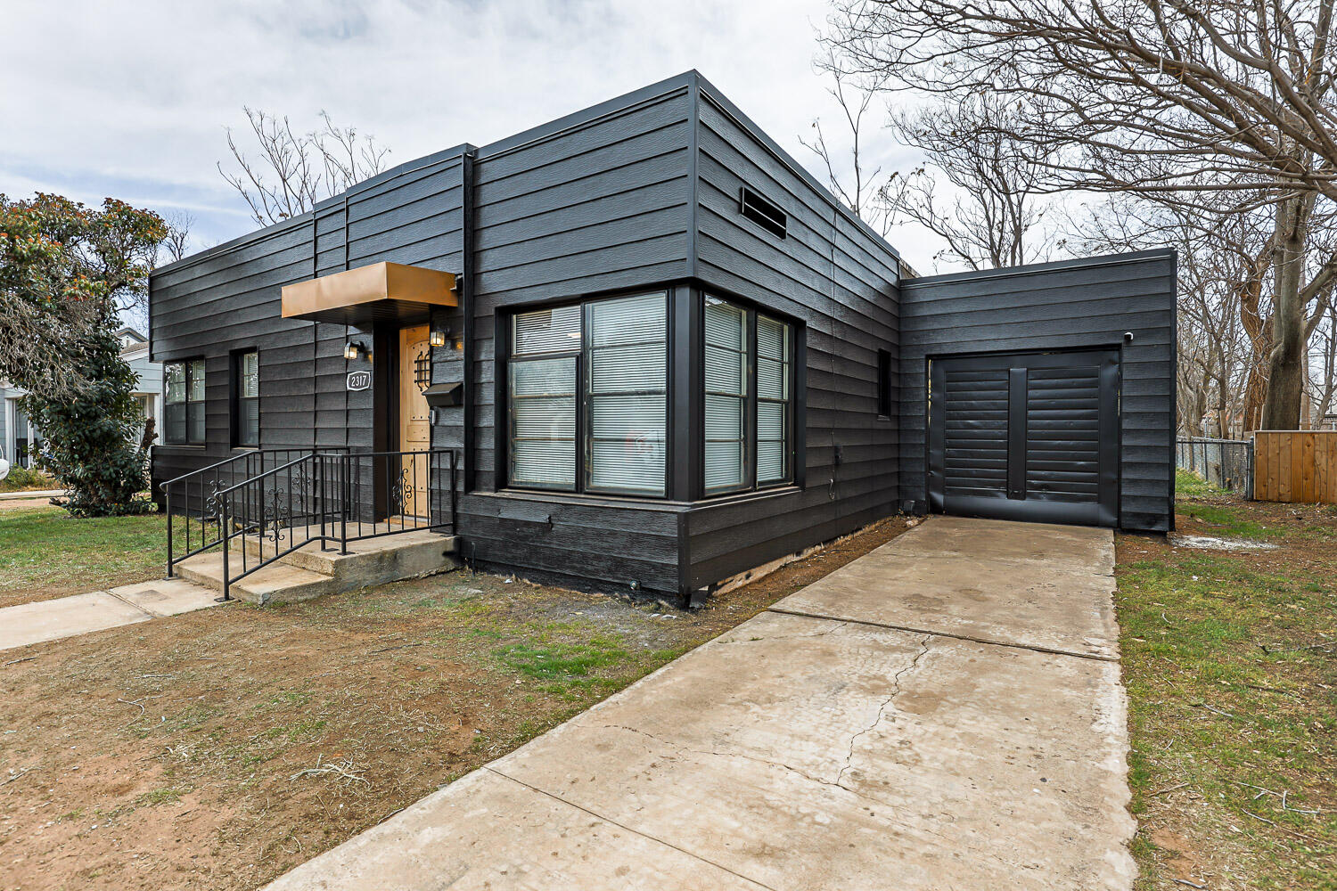 a view of house with backyard and sitting area