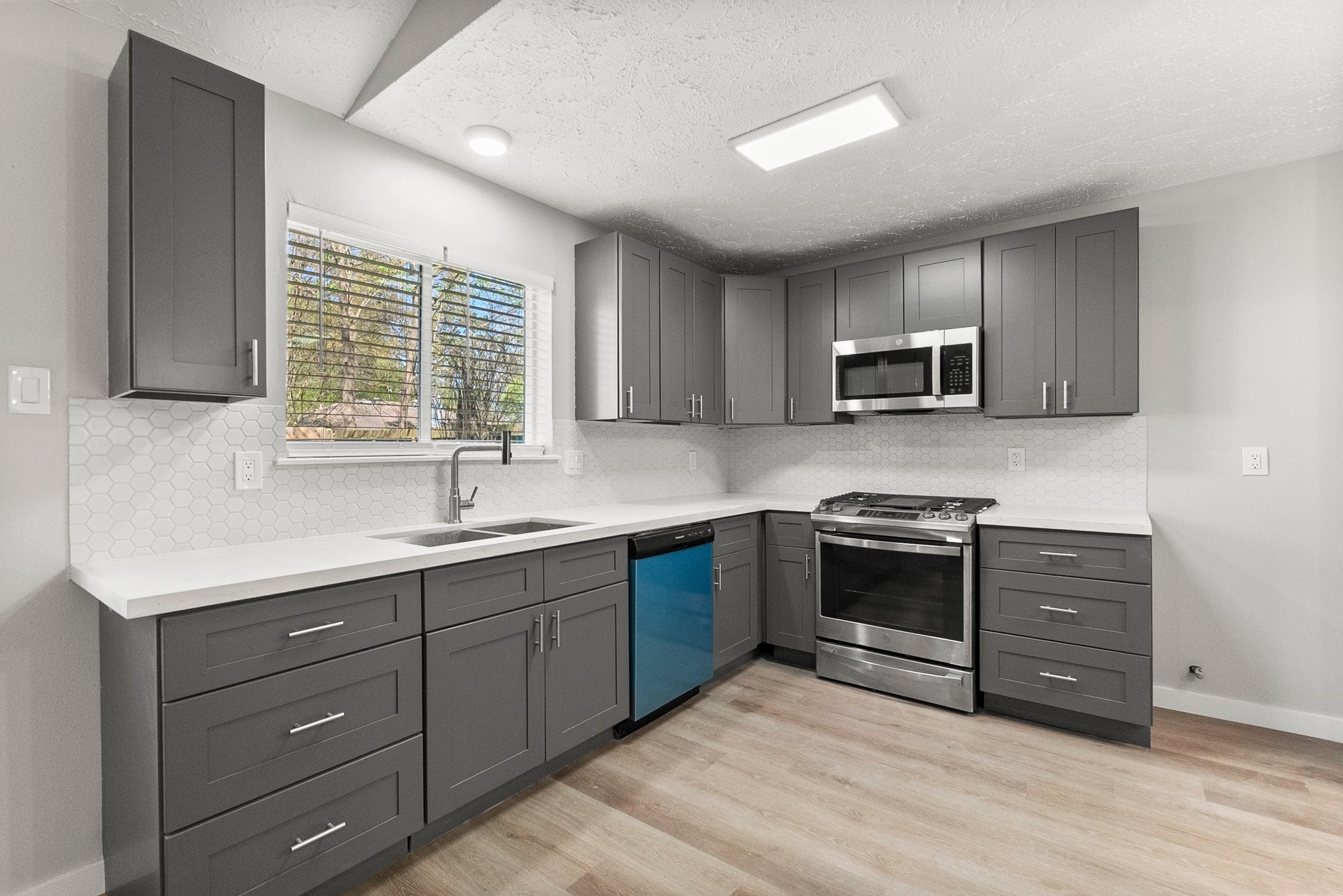 22907 Lemon Grove Drive Spring, TX 77373 - Photo 12 of 30 a kitchen with stainless steel appliances granite countertop a sink and cabinets