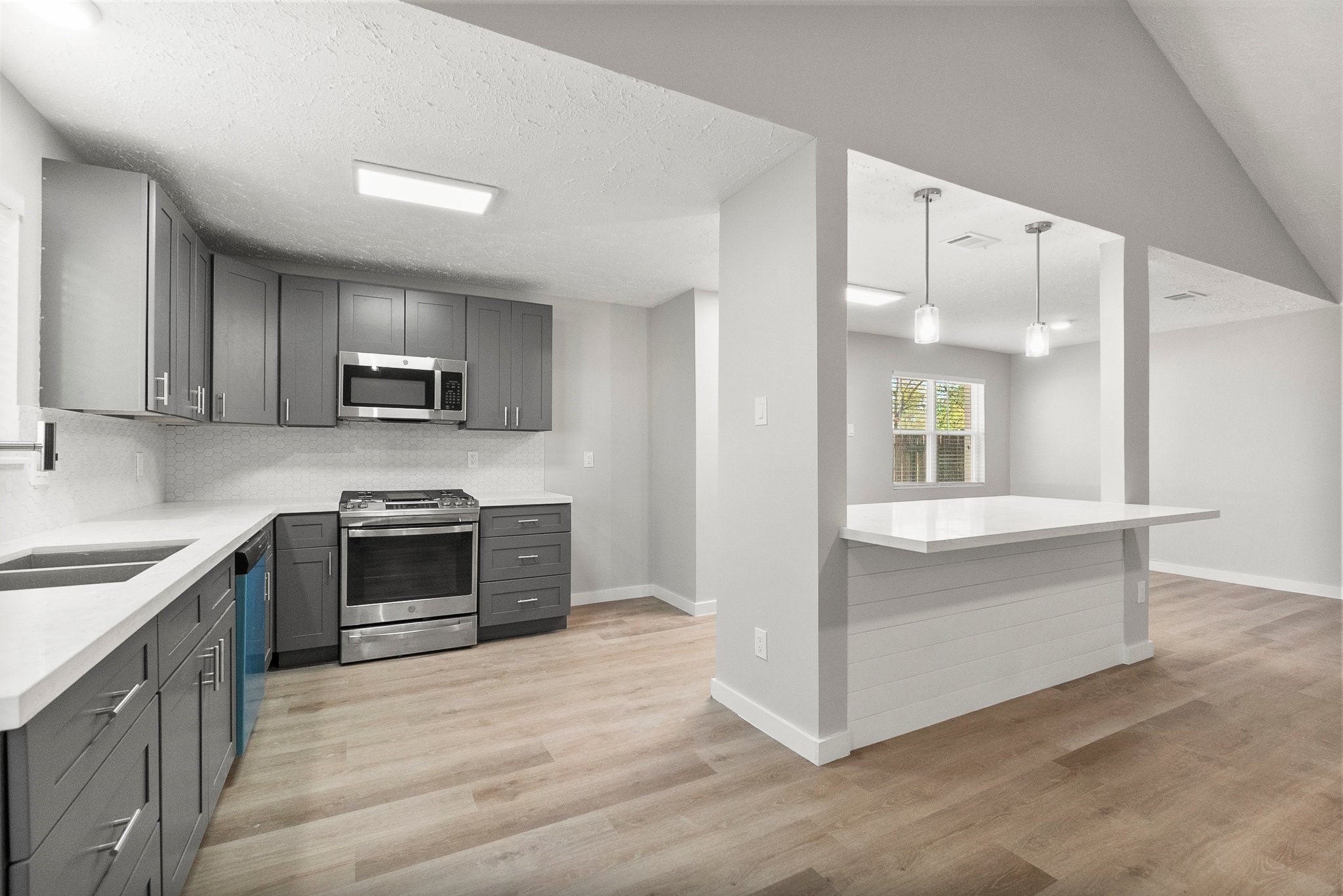 22907 Lemon Grove Drive Spring, TX 77373 - Photo 13 of 30 a kitchen with kitchen island granite countertop a stove and a sink