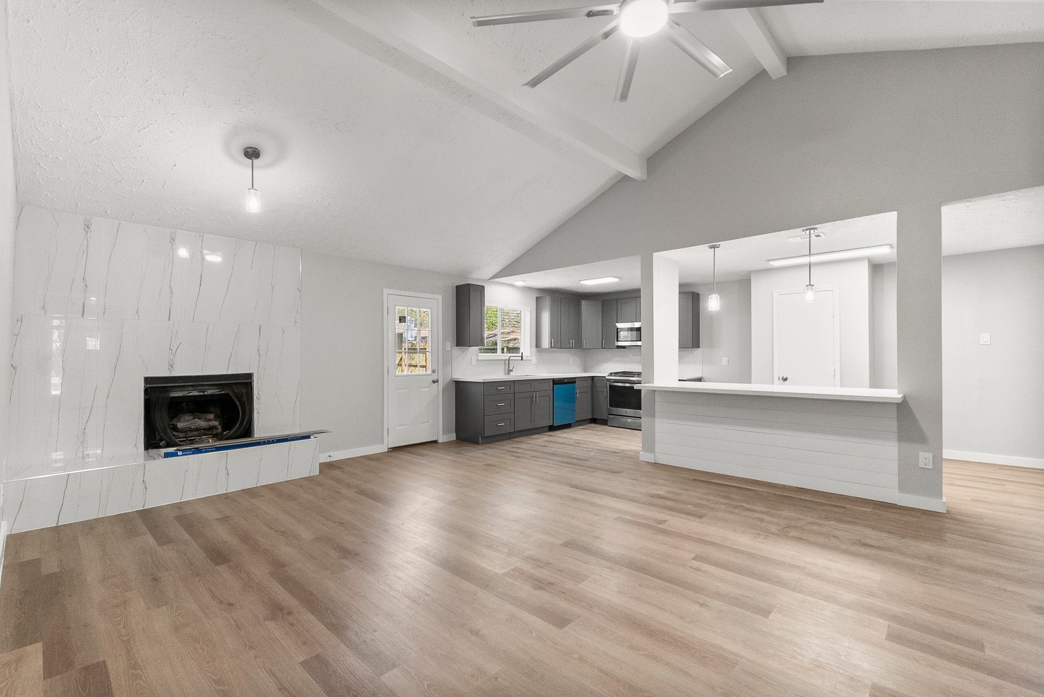 22907 Lemon Grove Drive Spring, TX 77373 - Photo 16 of 30 a large white kitchen with kitchen island a sink stainless steel appliances and cabinets