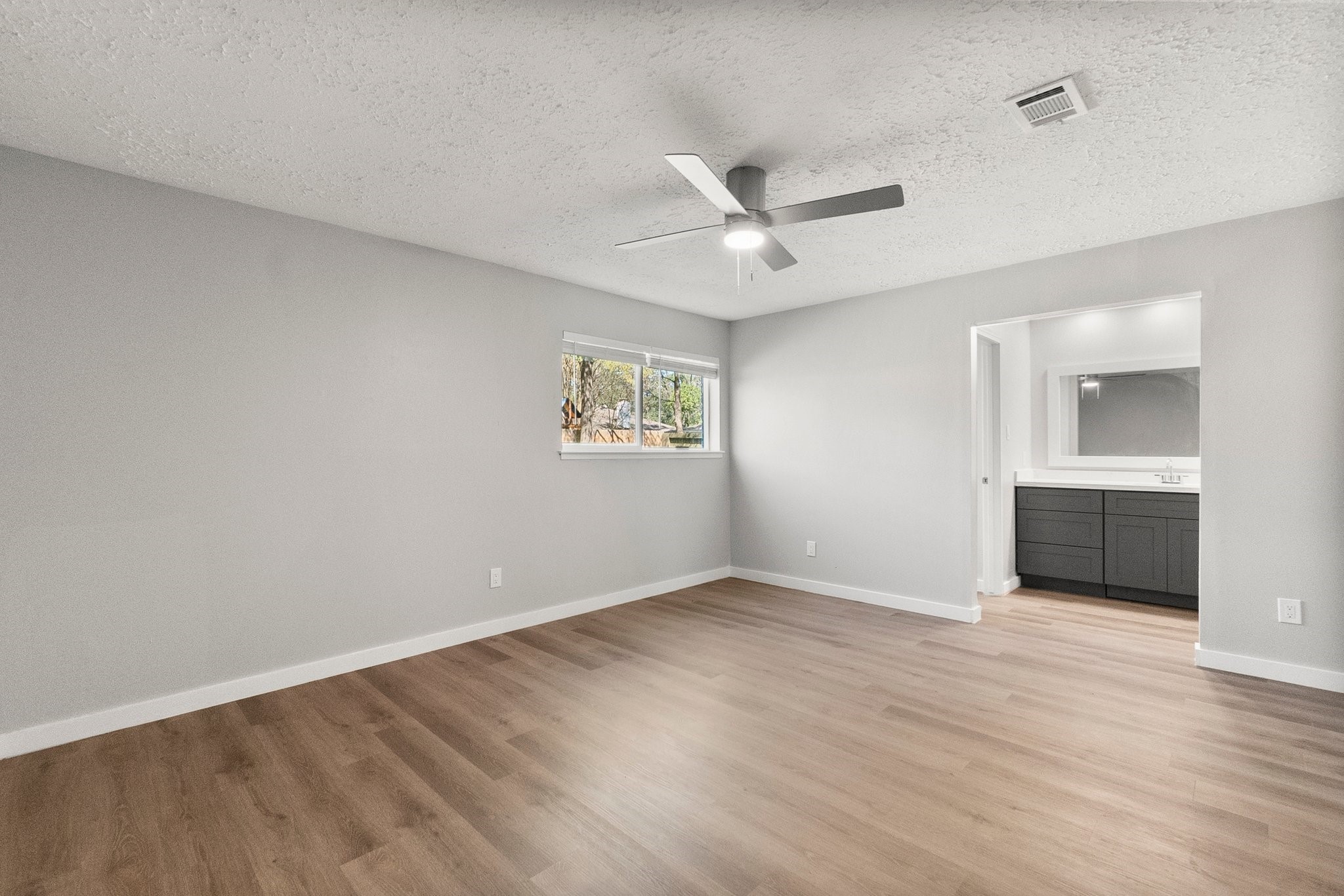 22907 Lemon Grove Drive Spring, TX 77373 - Photo 19 of 30 a view of an empty room with a window and wooden floor