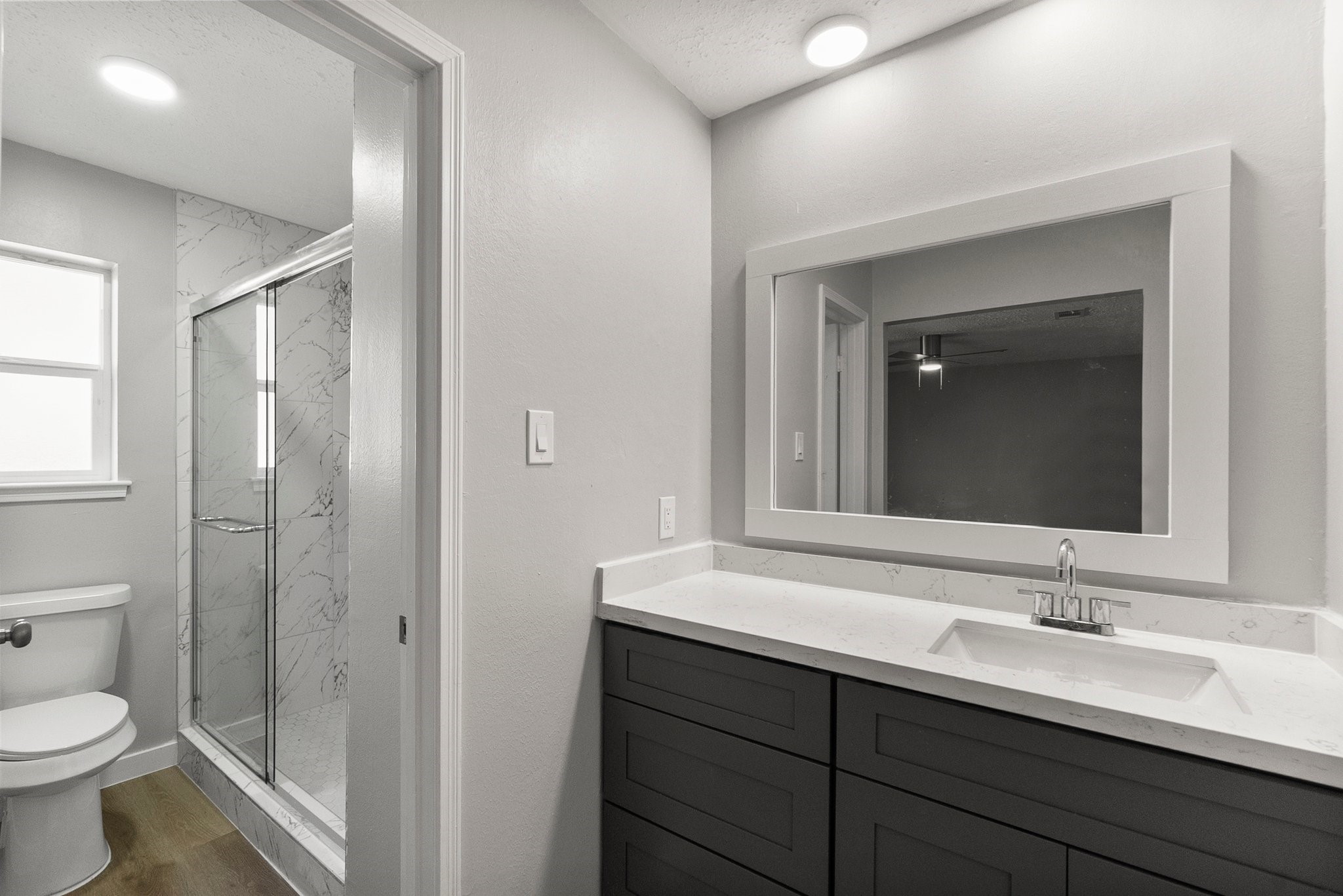 22907 Lemon Grove Drive Spring, TX 77373 - Photo 20 of 30 a bathroom with a double vanity sink toilet and mirror