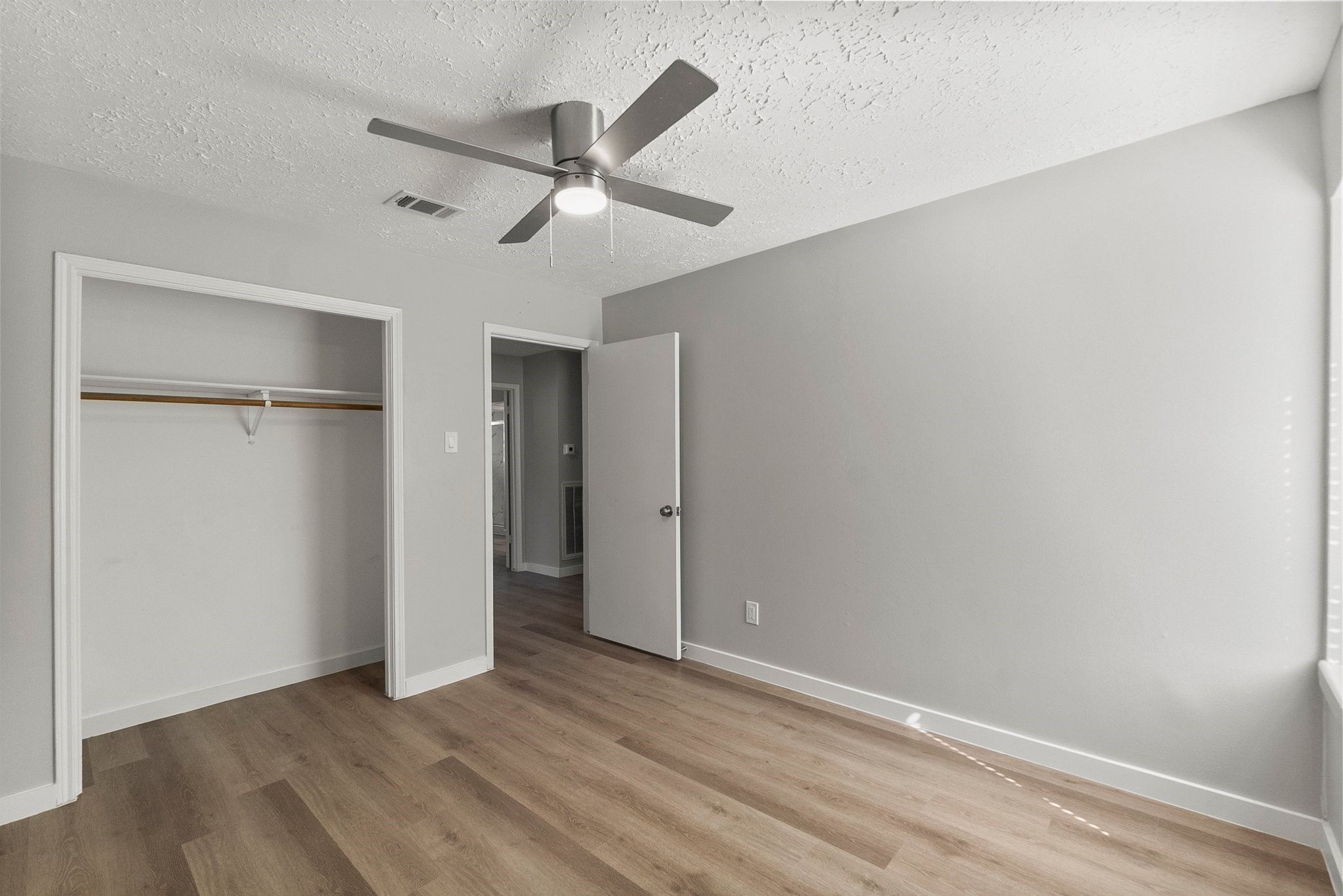 22907 Lemon Grove Drive Spring, TX 77373 - Photo 22 of 30 an empty room with wooden floor closet and fan
