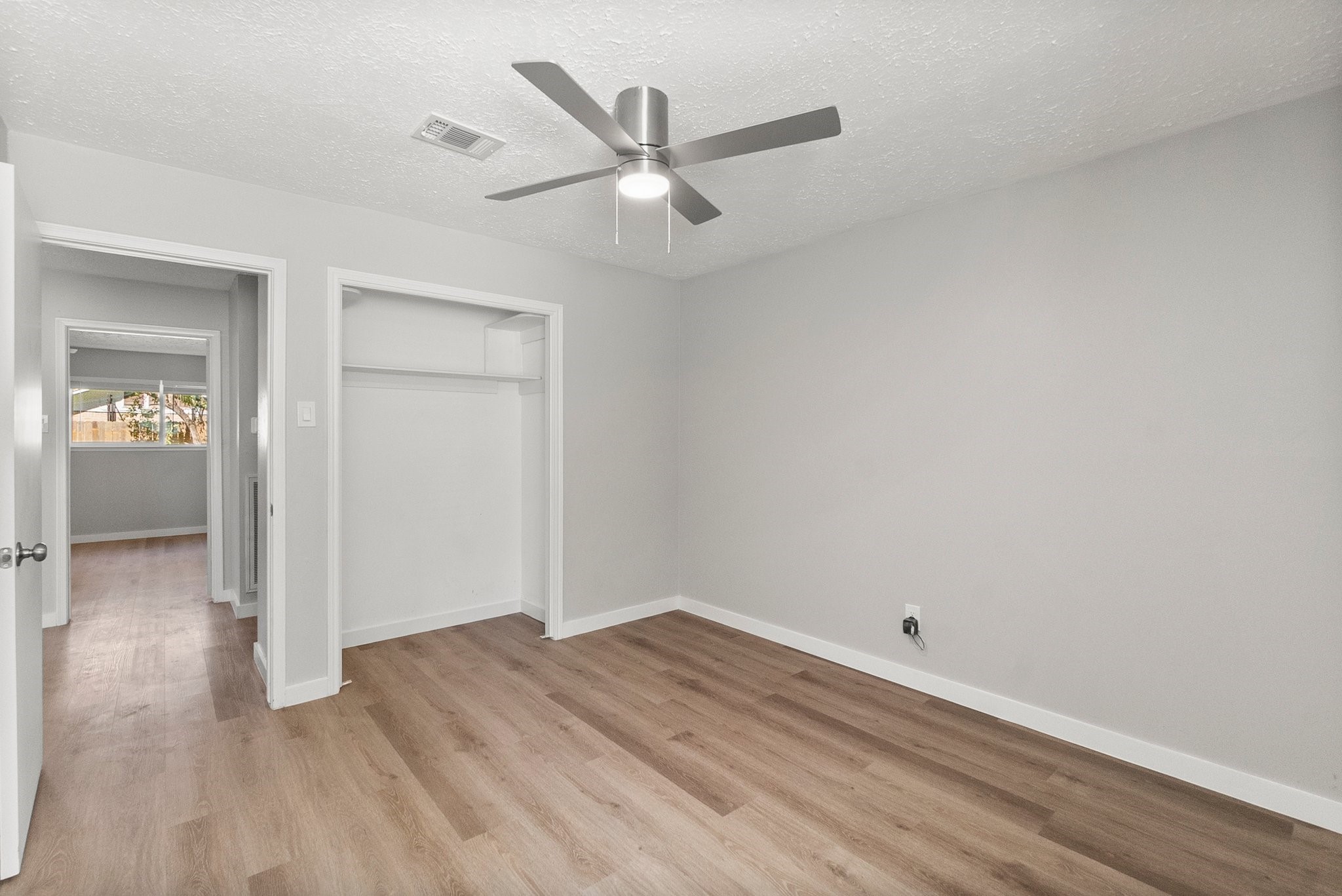 22907 Lemon Grove Drive Spring, TX 77373 - Photo 24 of 30 an empty room with wooden floor and a ceiling fan