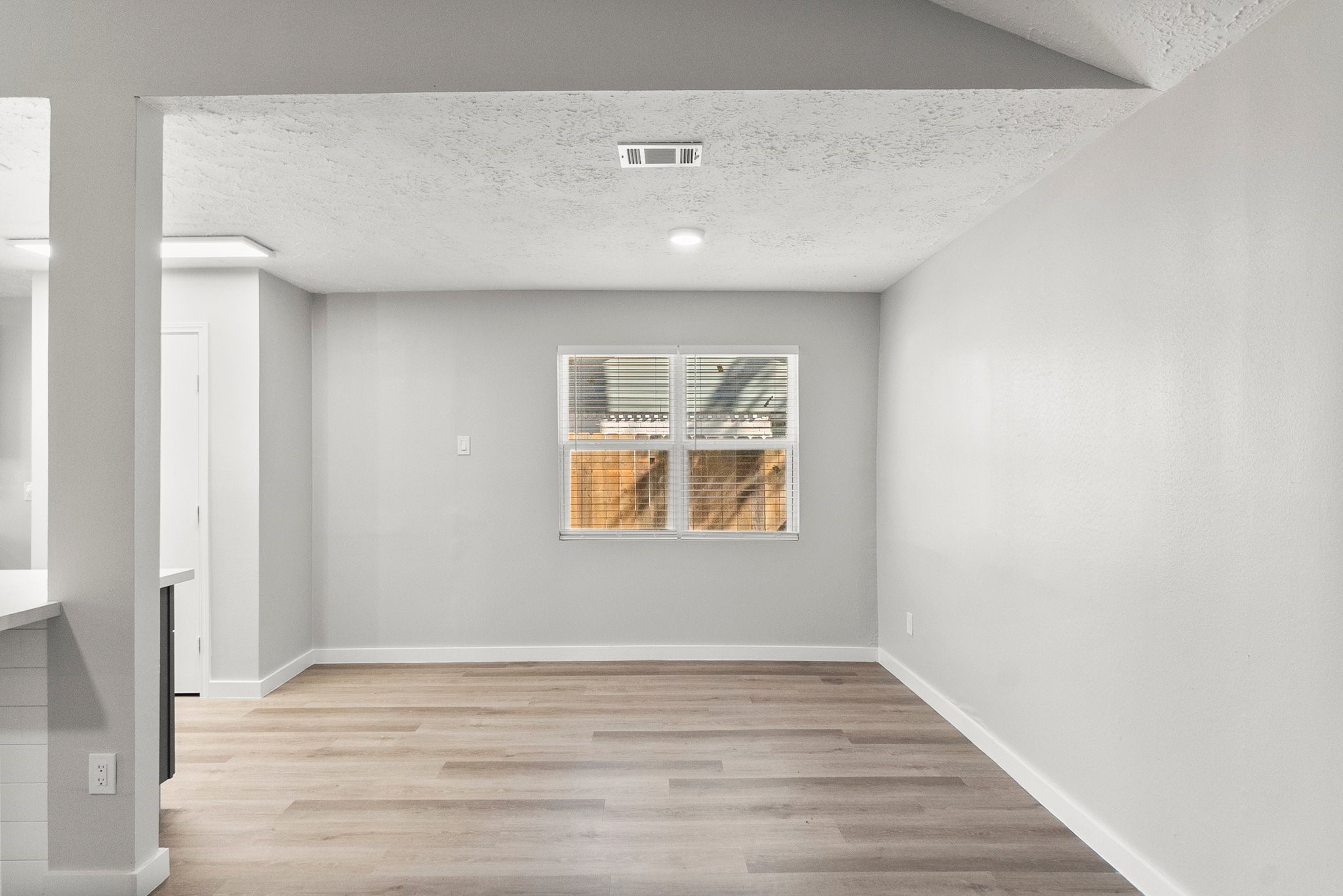 22907 Lemon Grove Drive Spring, TX 77373 - Photo 8 of 30 a view of an empty room with wooden floor and a window