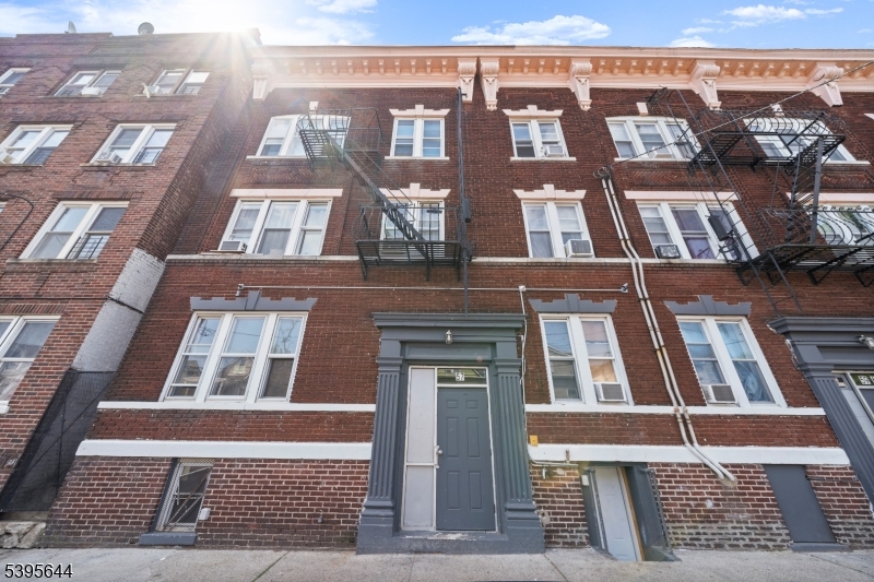 57 Henry Street, Unit A1 Passaic, NJ 07055 - Photo 1 of 14 a front view of a multi story residential apartment building