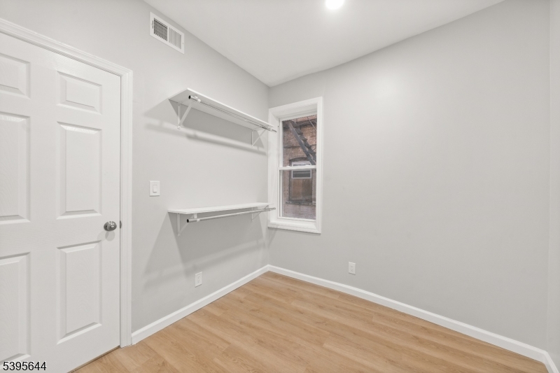 57 Henry Street, Unit A1 Passaic, NJ 07055 - Photo 12 of 14 wooden floor in an empty room