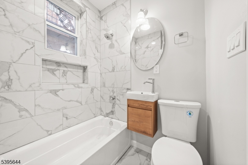 57 Henry Street, Unit A1 Passaic, NJ 07055 - Photo 9 of 14 a bathroom with a toilet a sink and bathtub