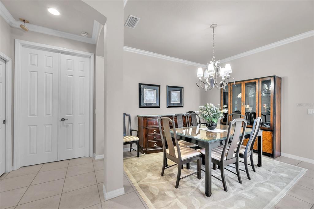 321 Silver Falls Drive Apollo Beach, FL 33572 - Photo 6 of 51 a view of a dining room with furniture and chandelier