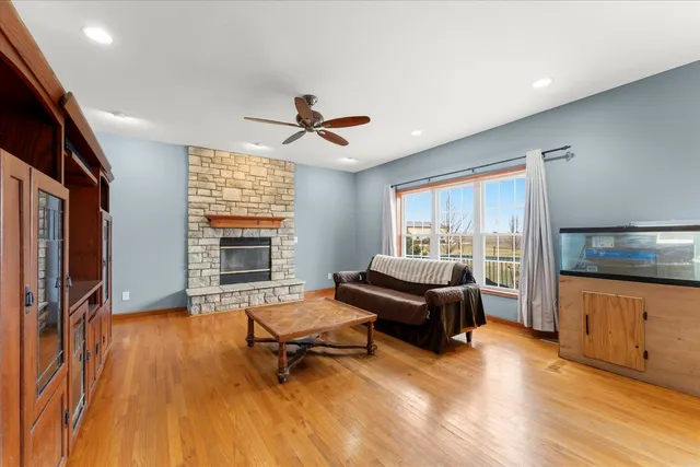 a living room with furniture flat screen tv and wooden floor