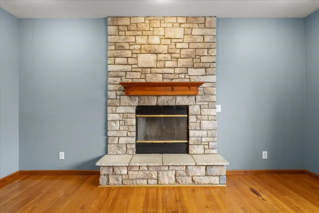 a living room with a fireplace and a wooden floor
